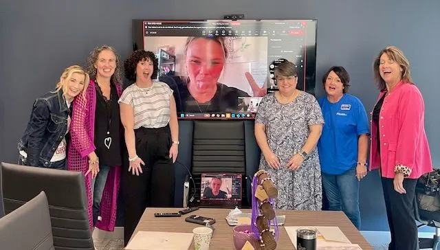 Group of women smiling together at a FEW ATL gathering